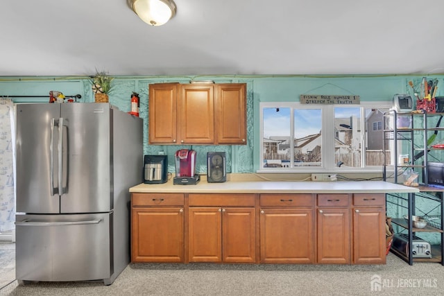 318 Bayview Ave, Union Beach, NJ 07735 - kitchen featuring freestanding refrigerator, light countertops, and brown cabinets