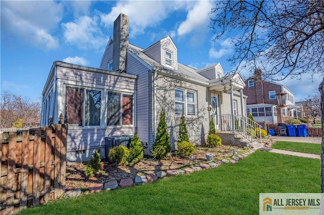 20 Cedar Ave, North Brunswick, NJ 08902 - view of front facade featuring a chimney and central air condition unit