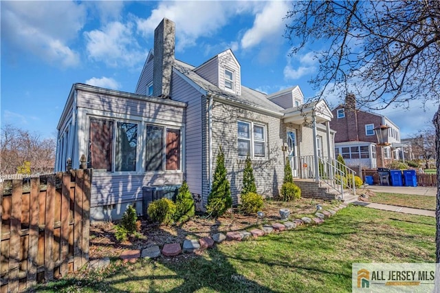 20 Cedar Ave, North Brunswick, NJ 08902 - view of home's exterior featuring a chimney and central AC
