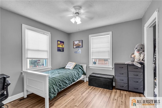 20 Cedar Ave, North Brunswick, NJ 08902 - bedroom featuring wood finished floors, a textured ceiling, baseboards, and ceiling fan