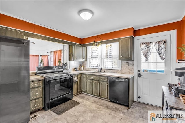 20 Cedar Ave, North Brunswick, NJ 08902 - kitchen with black appliances, healthy amount of natural light, a sink, light countertops, and ornamental molding