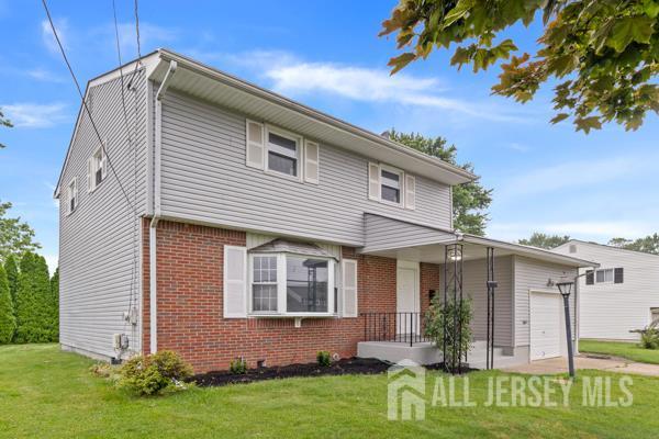 2164 Whitehorse Hamilton Square Rd, Hamilton, NJ 08690 - view of front of house with brick siding, a front yard, and a garage