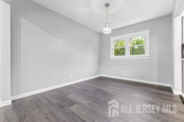 2164 Whitehorse Hamilton Square Rd, Hamilton, NJ 08690 - empty room featuring dark wood-style flooring and a chandelier