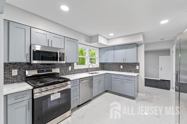 2164 Whitehorse Hamilton Square Rd, Hamilton, NJ 08690 - kitchen featuring appliances with stainless steel finishes, gray cabinets, light marble finish flooring, light countertops, and recessed lighting
