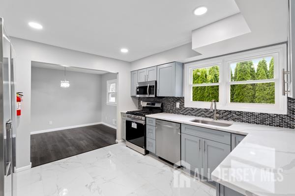 2164 Whitehorse Hamilton Square Rd, Hamilton, NJ 08690 - kitchen with appliances with stainless steel finishes, gray cabinetry, tasteful backsplash, and recessed lighting