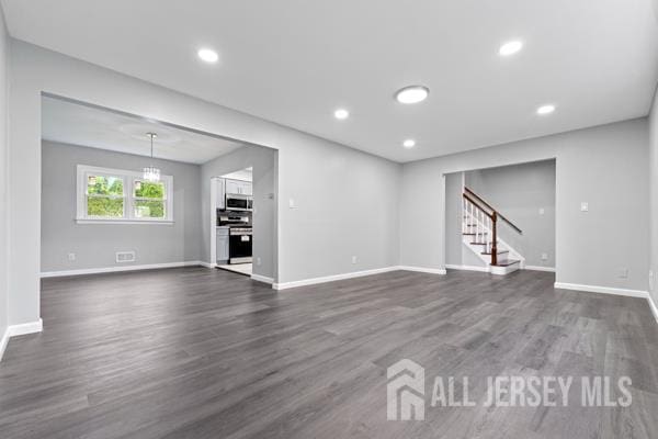 2164 Whitehorse Hamilton Square Rd, Hamilton, NJ 08690 - unfurnished living room featuring dark wood-style flooring, stairs, and recessed lighting