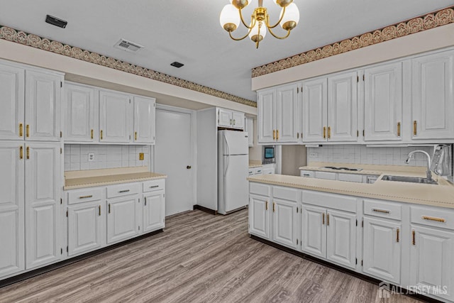 553-N Tilton Way, Monroe, NJ 08831 - kitchen featuring white appliances, a sink, backsplash, and white cabinets