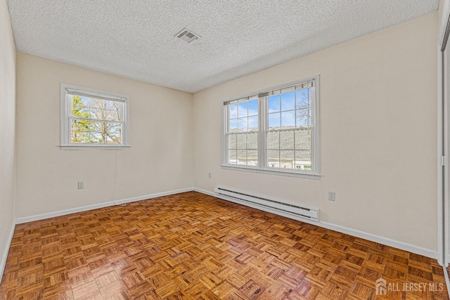 553-N Tilton Way, Monroe, NJ 08831 - spare room featuring a baseboard heating unit, plenty of natural light, a textured ceiling, and baseboards