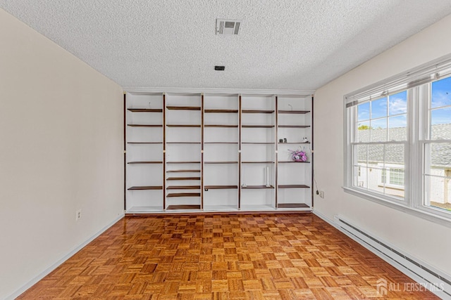 553-N Tilton Way, Monroe, NJ 08831 - empty room with baseboard heating, a textured ceiling, and baseboards