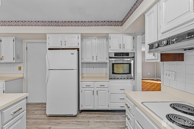 553-N Tilton Way, Monroe, NJ 08831 - kitchen with white appliances, light countertops, tasteful backsplash, white cabinetry, and light wood-style flooring