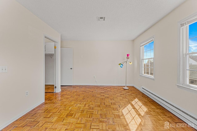 553-N Tilton Way, Monroe, NJ 08831 - spare room with a baseboard heating unit, baseboards, and a textured ceiling
