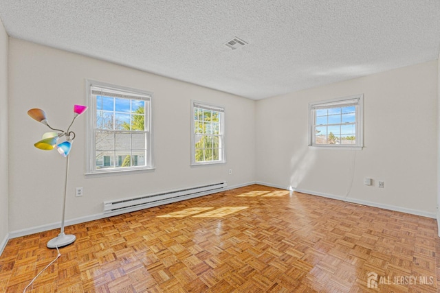 553-N Tilton Way, Monroe, NJ 08831 - unfurnished room featuring baseboard heating, healthy amount of natural light, a textured ceiling, and baseboards