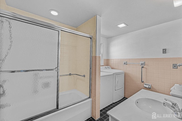 553-N Tilton Way, Monroe, NJ 08831 - full bath featuring tile walls, washing machine and clothes dryer, combined bath / shower with glass door, wainscoting, and vanity