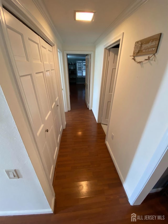 hall featuring ornamental molding and dark hardwood / wood-style floors