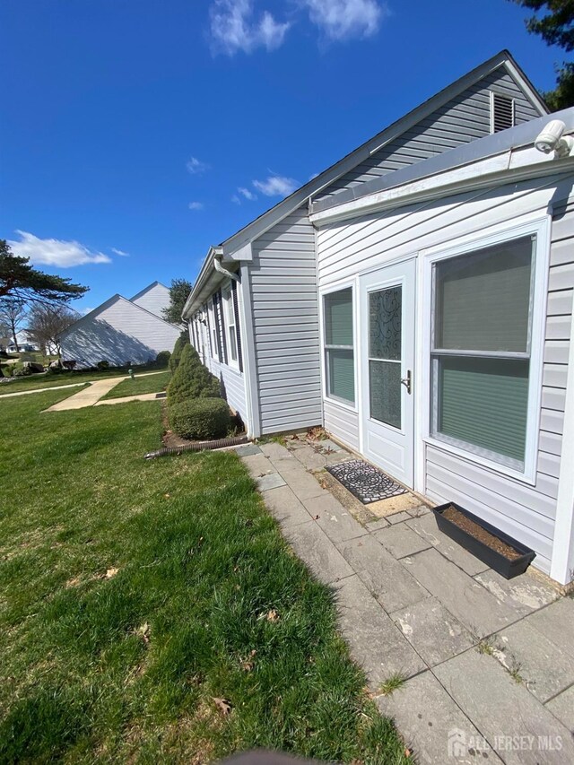 view of home's exterior with a lawn