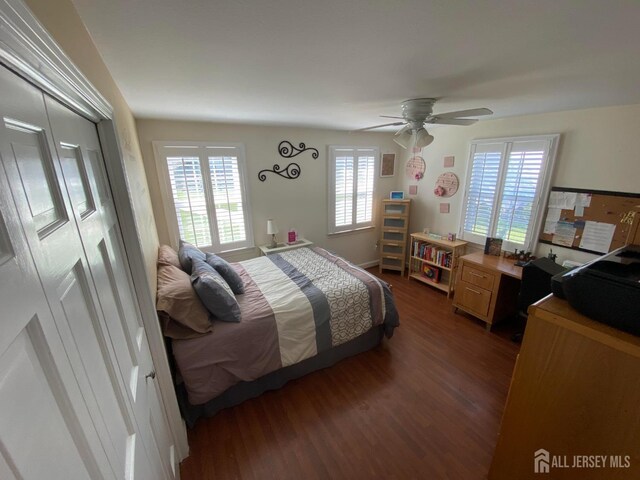 bedroom with dark hardwood / wood-style floors and ceiling fan