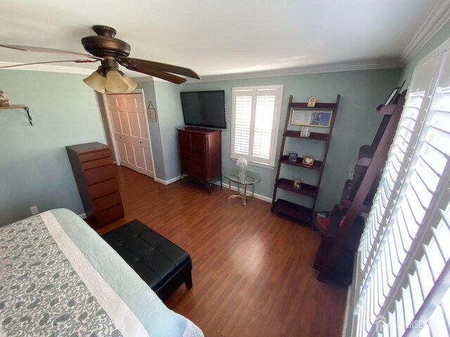 bedroom with crown molding, ceiling fan, and dark hardwood / wood-style floors