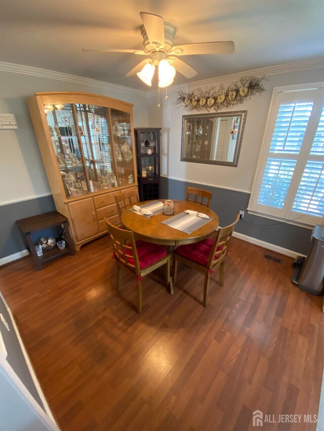 dining area with crown molding, wood-type flooring, and ceiling fan