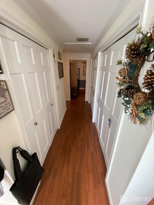 hallway with ornamental molding and dark hardwood / wood-style floors