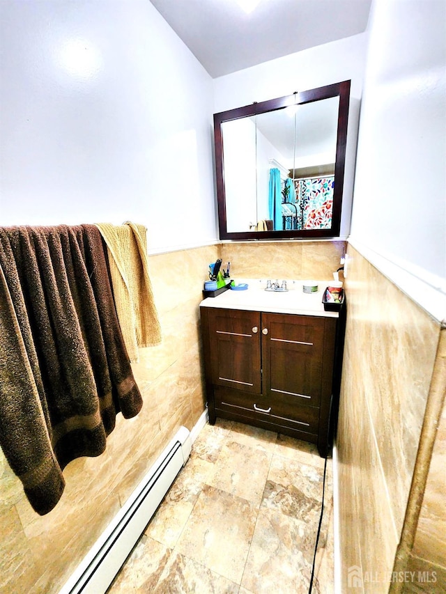 11 Melbourne St, Edison, NJ 08817 - bathroom with a baseboard heating unit, vanity, tile walls, and stone finish flooring