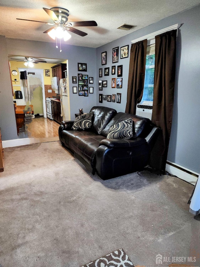 11 Melbourne St, Edison, NJ 08817 - carpeted living room with a ceiling fan, a textured ceiling, and a baseboard heating unit