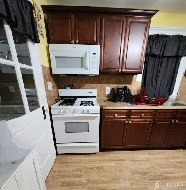 11 Melbourne St, Edison, NJ 08817 - kitchen with white appliances, light wood-type flooring, light countertops, and tasteful backsplash