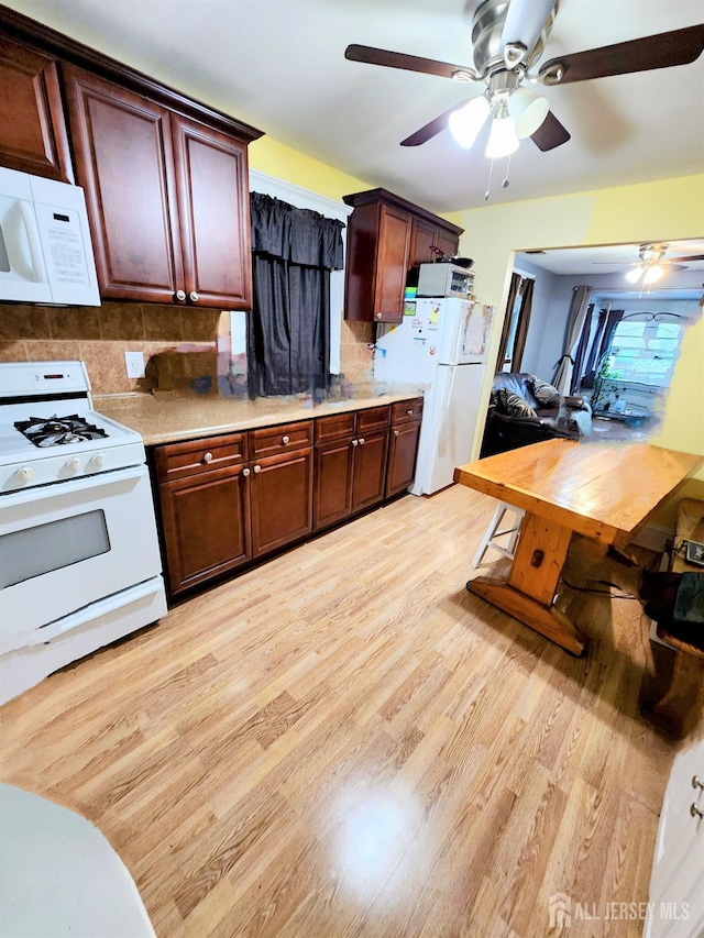 11 Melbourne St, Edison, NJ 08817 - kitchen featuring white appliances, a ceiling fan, light wood-type flooring, light countertops, and decorative backsplash