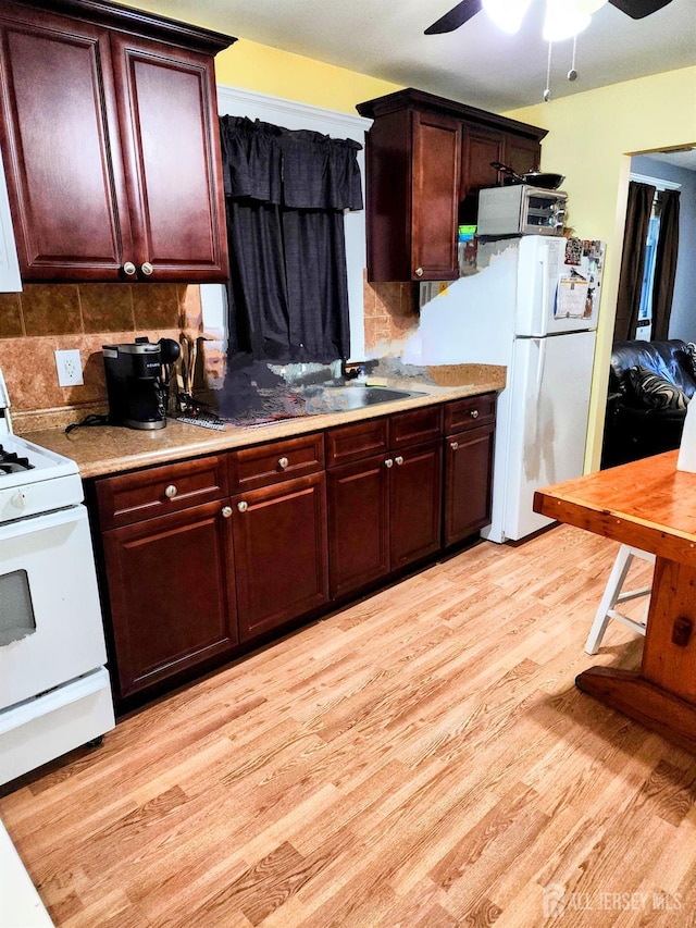 11 Melbourne St, Edison, NJ 08817 - kitchen with white appliances, light wood-style floors, a ceiling fan, and backsplash