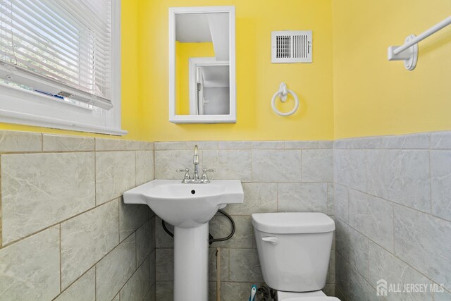 315 D St, Middlesex, NJ 08846 - half bath with toilet, a wainscoted wall, and tile walls