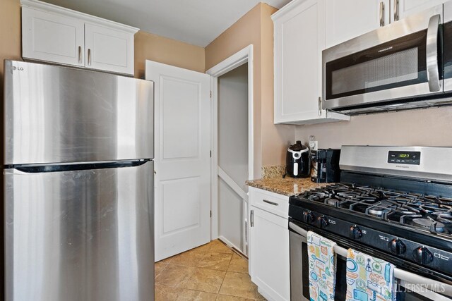 315 D St, Middlesex, NJ 08846 - kitchen featuring stainless steel appliances, white cabinets, light stone counters, and light tile patterned floors