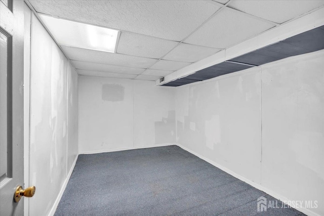 basement featuring carpet flooring and a drop ceiling