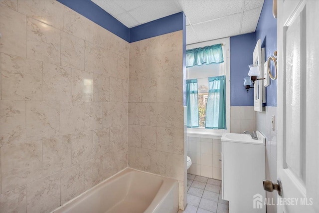 full bathroom with sink, shower / tub combination, tile walls, tile patterned flooring, and toilet