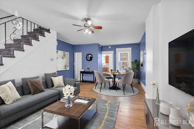 living room with ceiling fan and wood-type flooring