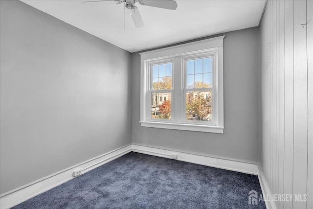 carpeted spare room featuring ceiling fan