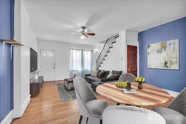 living room with ceiling fan and light hardwood / wood-style flooring