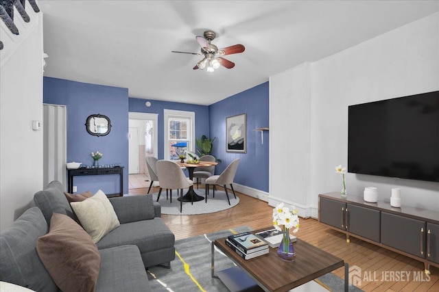 living room featuring ceiling fan and wood-type flooring