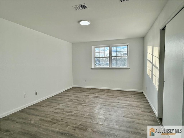 unfurnished room with light wood-type flooring