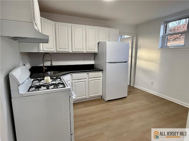 kitchen featuring white cabinetry, sink, white appliances, and light hardwood / wood-style floors