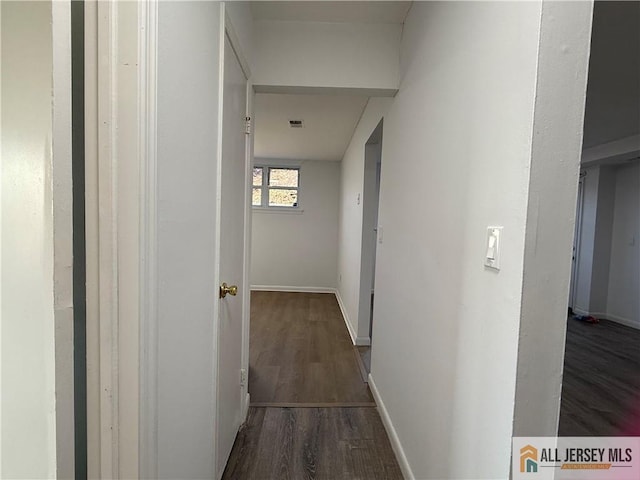 corridor with dark wood-type flooring