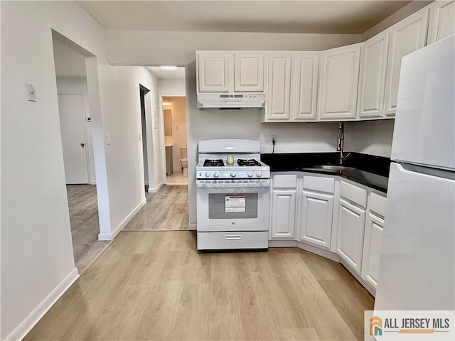 kitchen featuring white cabinetry, white appliances, and light hardwood / wood-style flooring