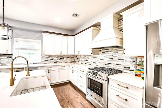 18 Rosewood Rd, Edison, NJ 08817 - kitchen with appliances with stainless steel finishes, premium range hood, light countertops, backsplash, and white cabinets