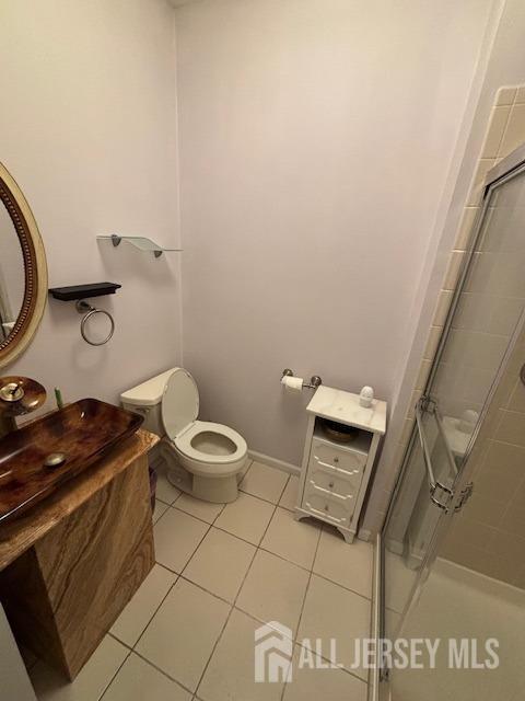 10 Eddie Ct, South Brunswick, NJ 08810 - bathroom with a shower stall, tile patterned flooring, toilet, and vanity