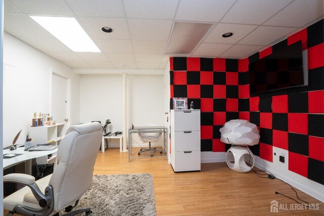 office space featuring a drop ceiling and hardwood / wood-style floors