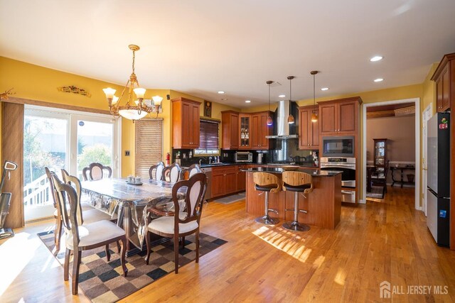 dining space featuring a notable chandelier and light hardwood / wood-style flooring