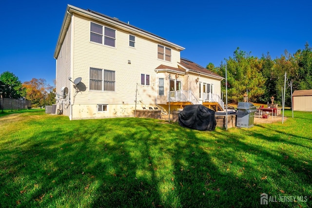 10 Eddie Ct, South Brunswick, NJ 08810 - back of property featuring a lawn, central air condition unit, and a wooden deck