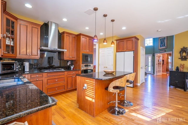 10 Eddie Ct, South Brunswick, NJ 08810 - kitchen featuring wall chimney exhaust hood, appliances with stainless steel finishes, light wood-style flooring, decorative backsplash, and decorative light fixtures