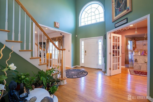 10 Eddie Ct, South Brunswick, NJ 08810 - foyer entrance with a high ceiling, wood finished floors, stairway, baseboards, and french doors