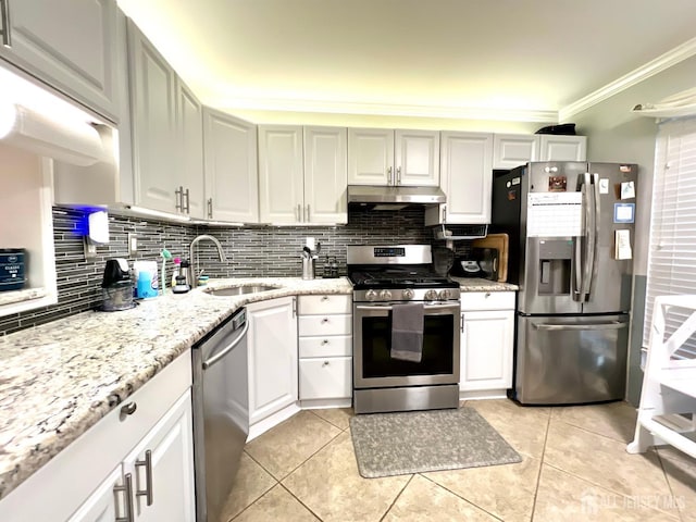 kitchen with sink, stainless steel appliances, white cabinets, and light tile patterned flooring