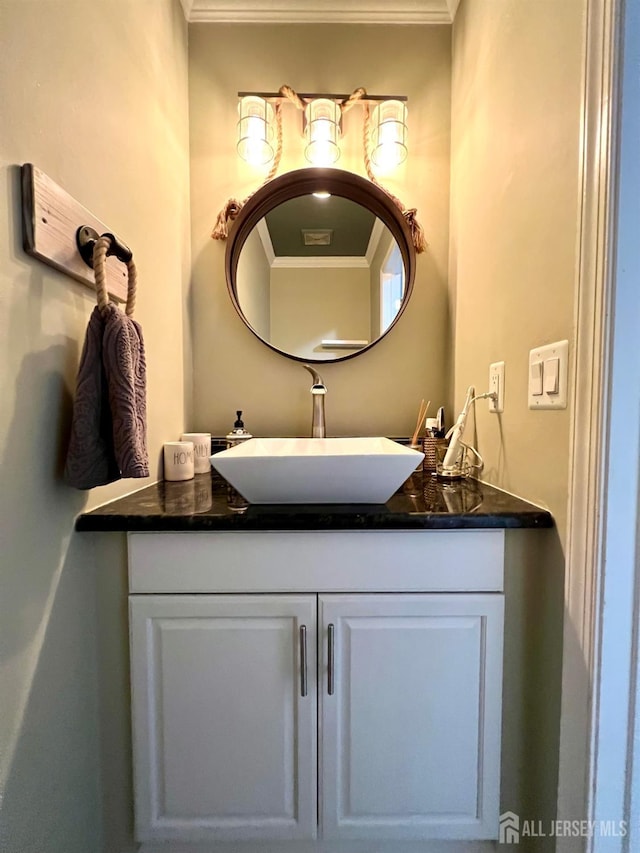 bathroom featuring crown molding and vanity