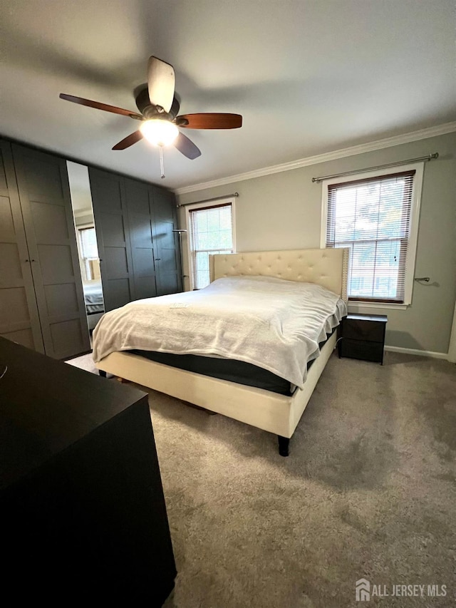 bedroom with ornamental molding, ceiling fan, and carpet